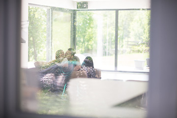 Image showing couple relaxing at  home with tablet and laptop computers