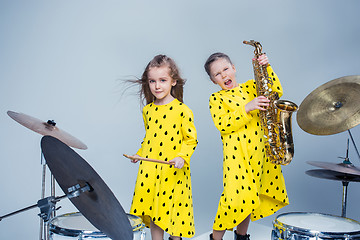 Image showing The teen music band performing in a recording studio