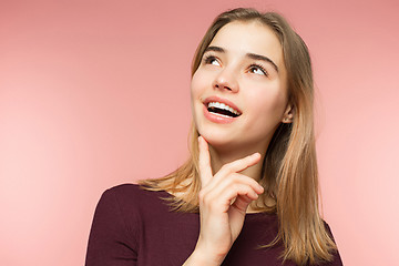 Image showing Woman smiling with perfect smile and white teeth on the pink studio background