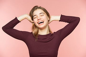 Image showing Woman smiling with perfect smile and white teeth on the pink studio background