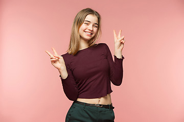Image showing Woman smiling with perfect smile and white teeth on the pink studio background and looking at camera