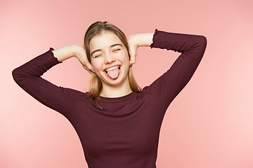 Image showing Woman smiling with perfect smile and white teeth on the pink studio background