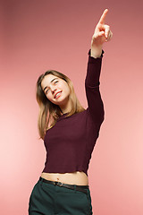 Image showing Woman smiling with perfect smile and white teeth on the pink studio background