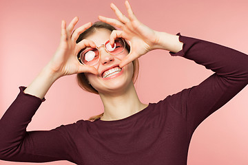 Image showing Woman smiling with perfect smile and white teeth on the pink studio background.