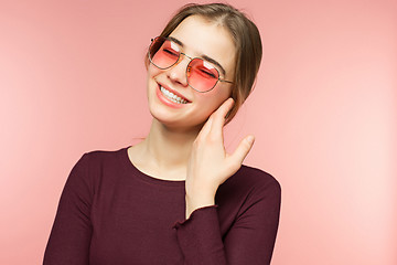 Image showing Woman smiling with perfect smile and white teeth on the pink studio background