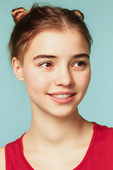 Image showing Woman smiling with perfect smile on the blue studio background and looking at camera