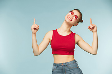 Image showing Woman smiling with perfect smile on the blue studio background