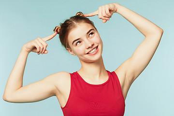 Image showing Woman smiling with perfect smile on the blue studio background