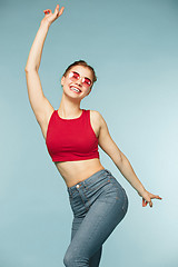 Image showing Woman smiling with perfect smile on the blue studio background