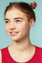 Image showing Woman smiling with perfect smile on the blue studio background and looking at camera