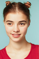 Image showing Woman smiling with perfect smile on the blue studio background and looking at camera