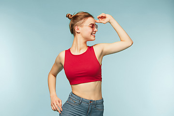 Image showing Woman smiling with perfect smile on the blue studio background