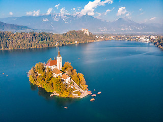 Image showing Aerial view of Bled island on lake Bled, and Bled castle and mountains in background, Slovenia.