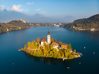 Image showing Aerial view of Bled island on lake Bled, and Bled castle and mountains in background, Slovenia.