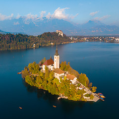 Image showing Aerial view of Bled island on lake Bled, and Bled castle and mountains in background, Slovenia.