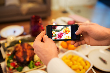Image showing hands photographing food at christmas dinner