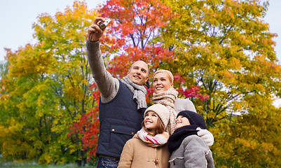 Image showing family taking selfie by camera in autumn park