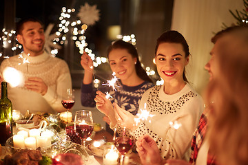 Image showing happy friends celebrating christmas at home feast