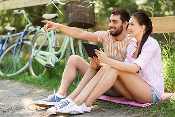 Image showing couple with tablet pc and bicycles at summer park