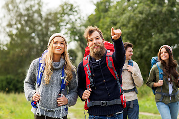 Image showing friends or travelers with backpacks hiking