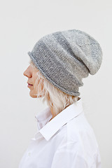 Image showing Wwoman in warm grey beanie wool knitted hat.