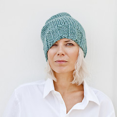 Image showing Woman in warm turquoise beanie wool knitted hat.