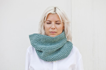 Image showing Woman in warm turquoise green wool knitted snood.