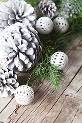 Image showing Evergreen fir tree branch, white pine cones and balls.