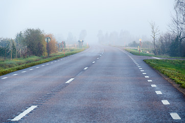 Image showing Foggy road by morning sunshine