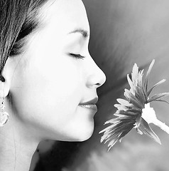 Image showing Relaxed Calm Girl Smelling A Big Flower