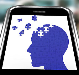 Image showing Head Puzzle On Smartphone Shows Smartness