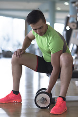 Image showing handsome man working out with dumbbells