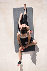 Image showing woman with personal trainer doing morning yoga exercises top vie