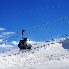 Image showing Gondola lift on ski resort at sun wind day