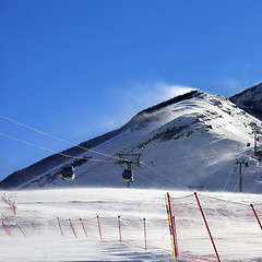 Image showing Gondola lift on ski resort at windy winter day