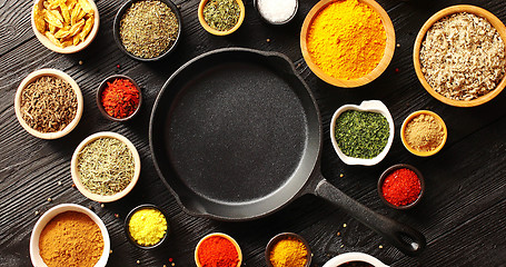 Image showing Pan surrounded by bowls with spices