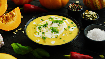 Image showing Pumpkin soup in bowl sprinkled with herbs