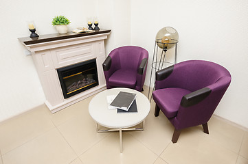 Image showing Lounge area with chairs and fireplace