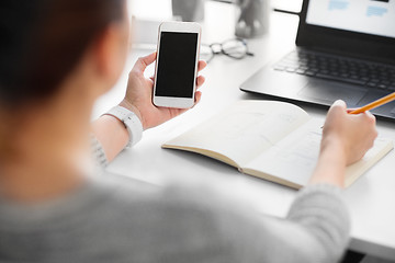 Image showing web designer working on smartphone user interface