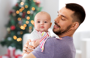 Image showing father with baby daughter over christmas tree