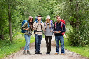 Image showing friends or travelers hiking with backpacks and map