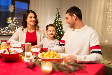 Image showing happy family having christmas dinner at home