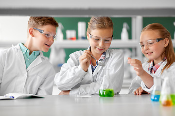 Image showing kids with test tube studying chemistry at school