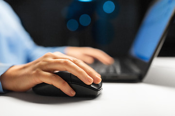 Image showing close up of female hand using computer mouse