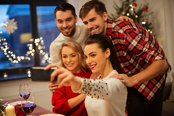 Image showing friends taking selfie at christmas dinner