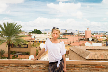 Image showing Woman admiring traditional moroccan architecture in one of the palaces in medina of Marrakesh, Morocco.