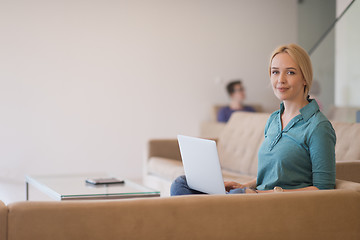 Image showing Young woman using laptop at home