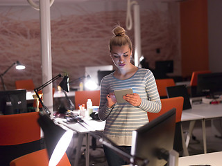 Image showing woman working on digital tablet in night office
