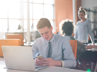 Image showing businessman working using a laptop in startup office