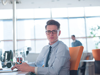 Image showing businessman working using a laptop in startup office